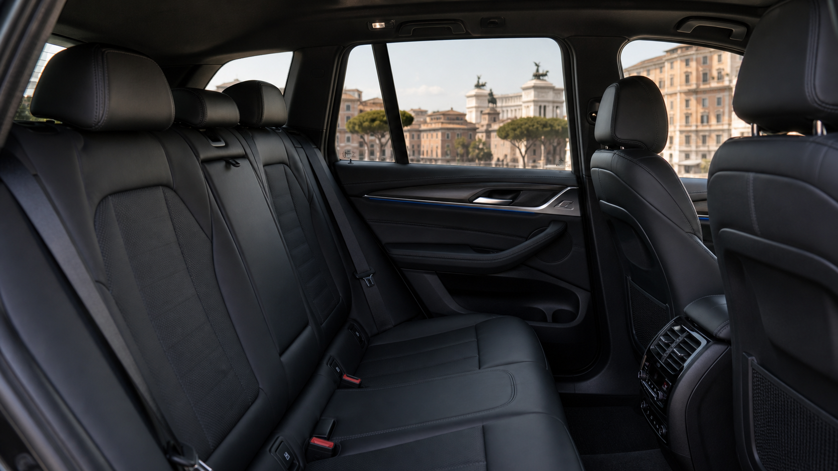 Black BMW X3 SUV interior with Rome visible through the window
